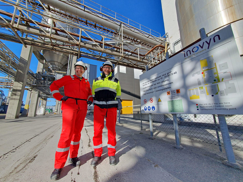 two persons, whole figure, posing, standing in industrial environment