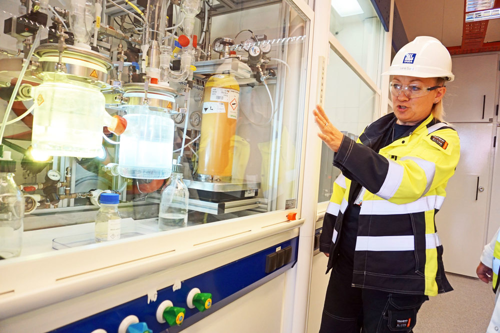 woman showing test rig at the lab