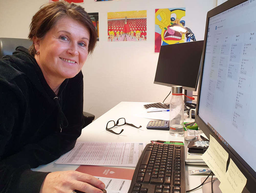 woman sitting at desk and monitor