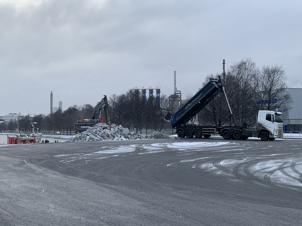 vehicle unloading stone masses on a construction site.