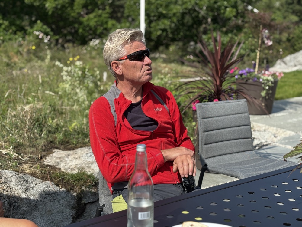 man sitting in chair, garden, red jumper, sunglasses