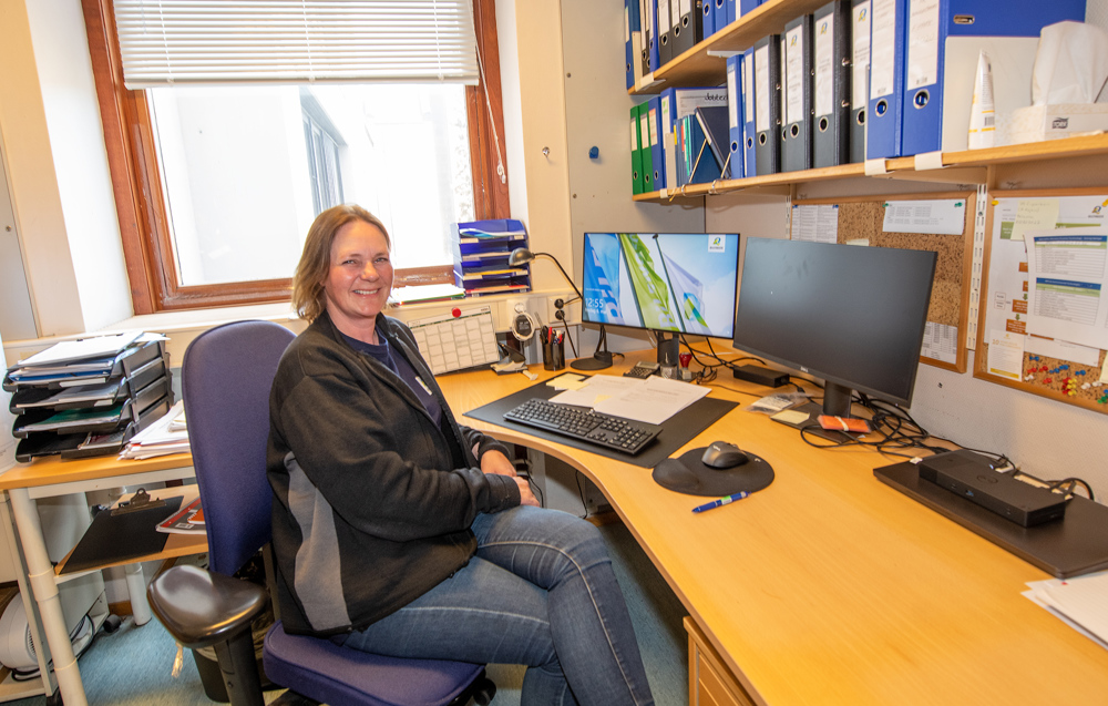 woman sitting by the desk in an office