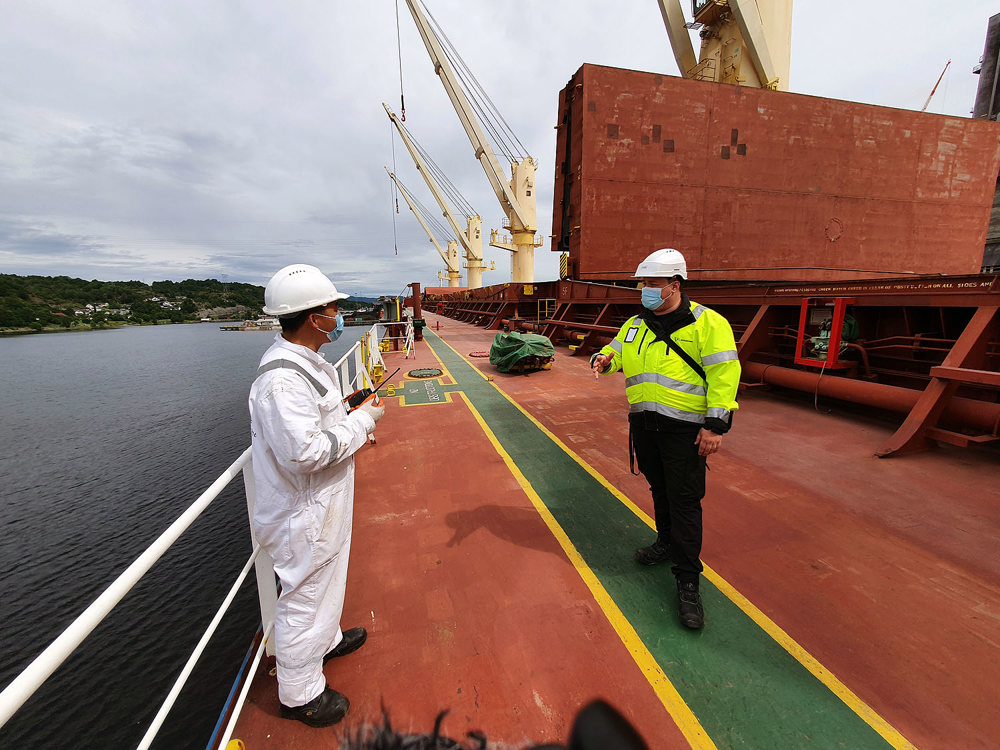 two men talking on vessel