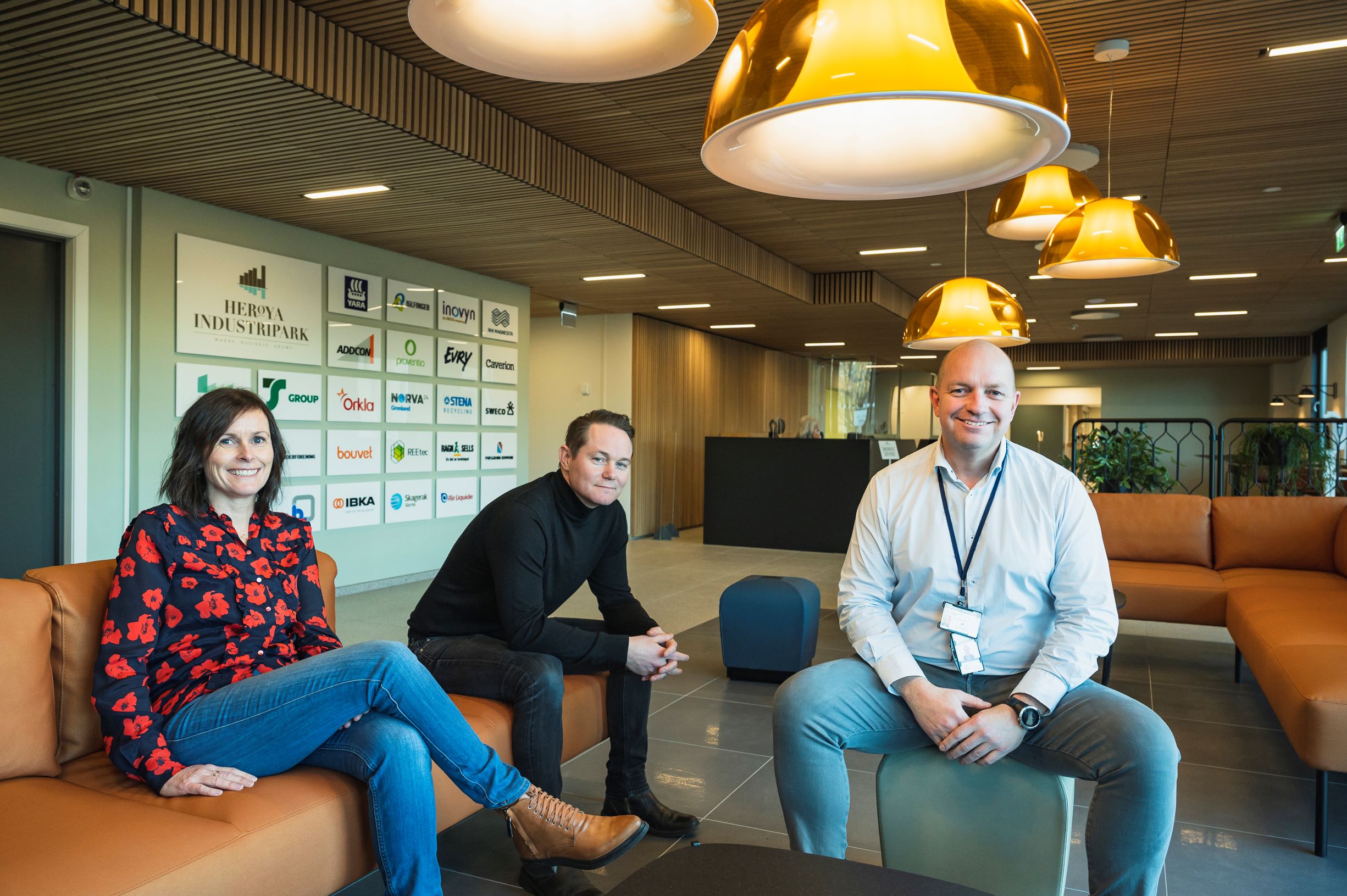 three persons sitting in new furniture in a newly renovated reception area