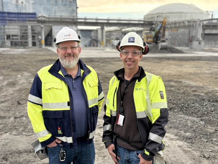 two men, yellow jackets, white helmets, industry, cleared plot