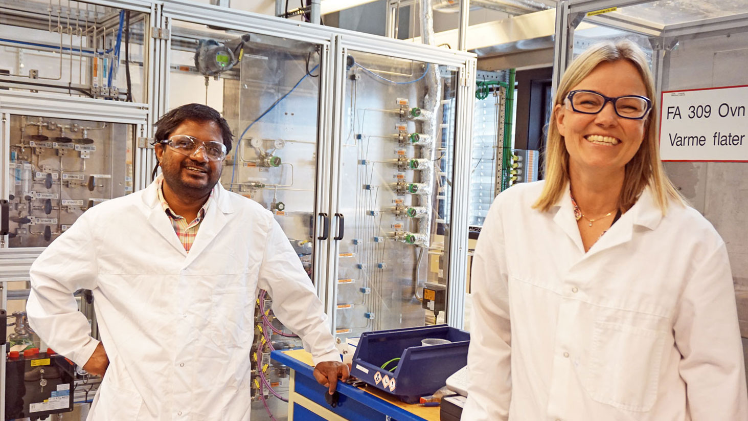 two persons in white lab coats in a pilot lab