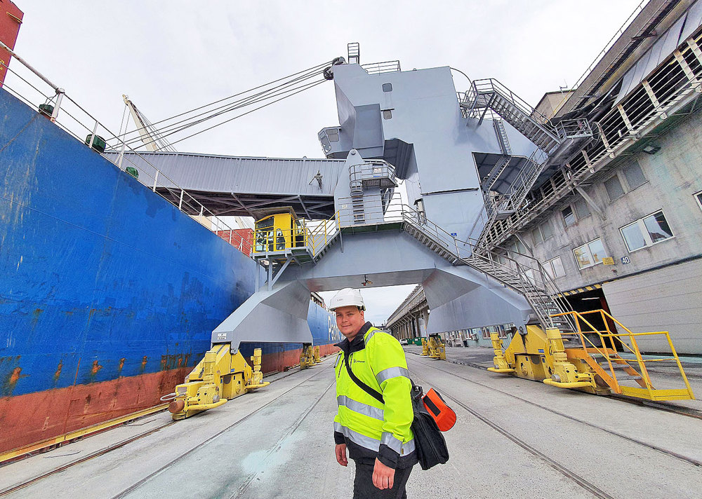 man next to bulk ship at quay