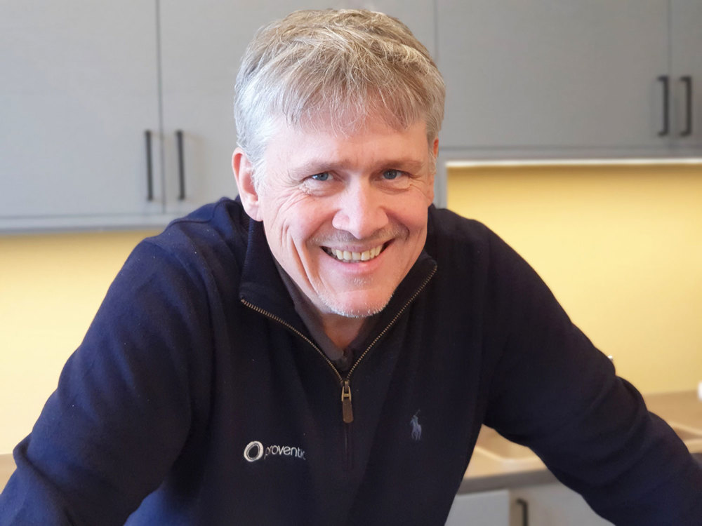portrait man, posing, grey cupboards in background