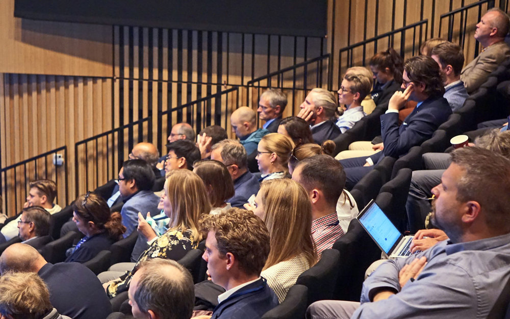 people sitting on tribune listning to debate